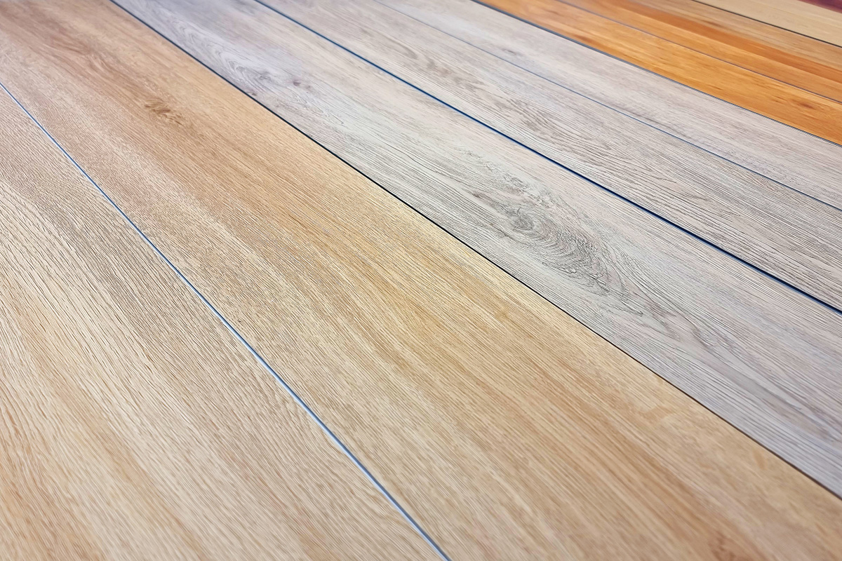 Different types of SPC flooring laid out on ground