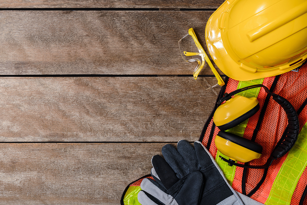 Safety hat, glasses, and vest on floor